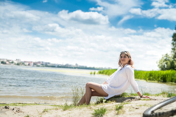 Fototapeta na wymiar young beautiful woman in white dress enjoy nature near the lake, freedom