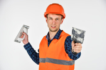 Man master plasterer in protective hard hat, finishing walls concept