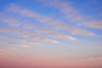 Beautiful pink clouds on the blue sky during sunset. Beautiful natural background