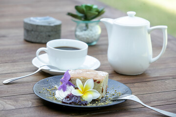 Raisin bread decorated with edible flowers served on the wooden table	