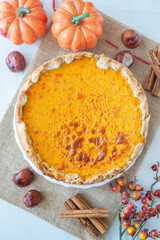 slice of pumpkin pie on plate with pumpkins