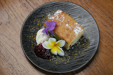 Raisin bread decorated with edible flowers served on the wooden table	