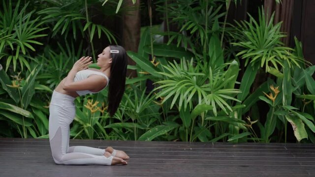 Yoga instructor, in outdoor exercise. gorgeous asian young woman practicing yoga outdoor