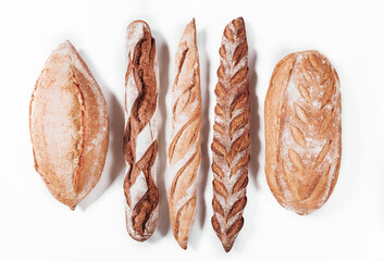 Various types of Bakery bread - fresh rustic crusty loaves of bread and baguette on white...