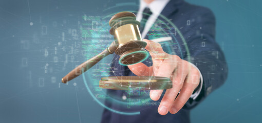 Businessman holding a Justice hammer and data - 3d rendering - obrazy, fototapety, plakaty