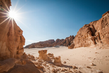 Desert landscape with blue sky and sun
