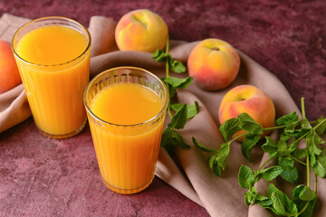 Glasses of fresh peach juice on table