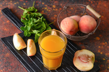 Glass of fresh peach juice on table