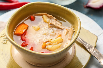 Bowl of tasty rice soup on table, closeup