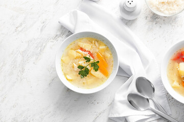 Bowl of tasty rice soup on table