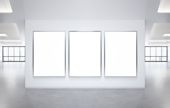 Three vertical frames Mockup hanging on office wall. Mock up of a billboards in modern company interior