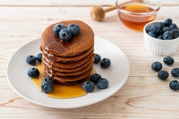 chocolate pancake stack with blueberry and honey