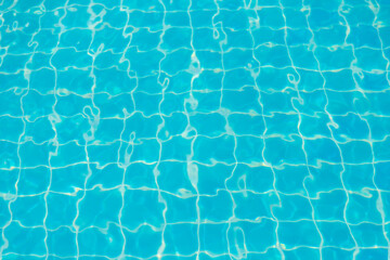 Reflections from the water in the blue swimming pool