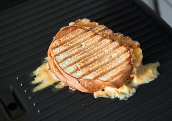 homemade panini with melted cheese on grill pan