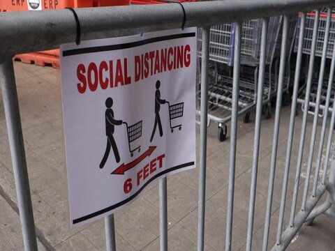 shopping social distancing sign and shopping carts in background corona virus