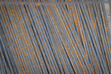 Old rusted steel bars laid on the ground.