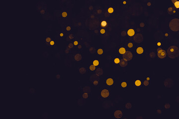 Fantasy gold bokeh sparkle from light on black