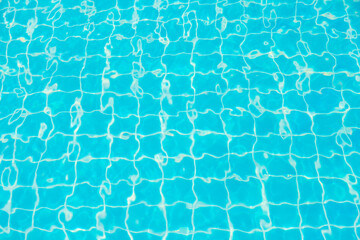 Reflections from the water in the blue swimming pool