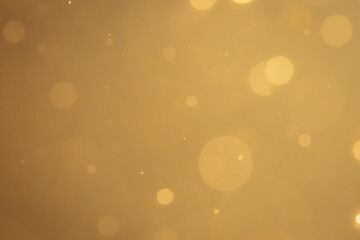 Dark Abstract Gold bokeh sparkle on black background