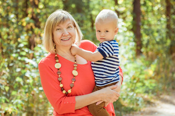 Fototapeta premium Happy grandma with grandson embracing outdoor