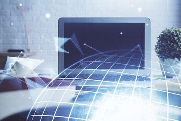 Double exposure of desktop with computer and world map hologram. International data network concept.