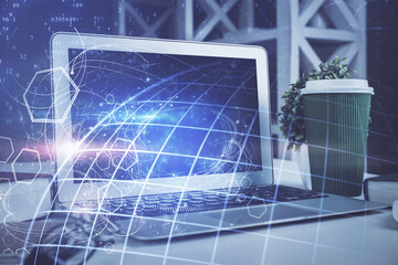 Double exposure of desktop with computer and world map hologram. International data network concept.