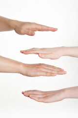 man's and woman's hands on white background