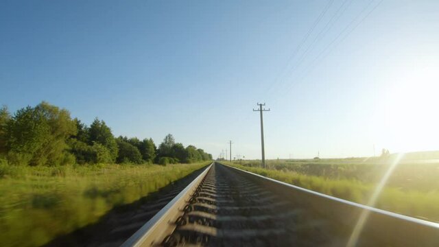 Fast flight close to train tracks in a clear sunny day