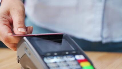 NFC credit card payment. Woman paying with contactless credit card with NFC technology. Wireless money transaction. Wireless payment