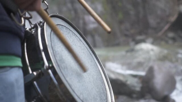 playing a drum in a river.