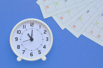 White clock on a blue background   