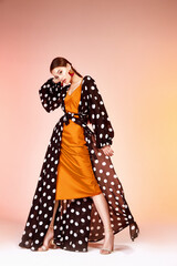 Glamour fashion woman long brunette hair natural evening makeup wear sexy silk long dress polka dot...