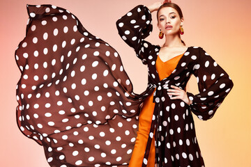 Glamour fashion woman long brunette hair natural evening makeup wear sexy silk long dress polka dot...