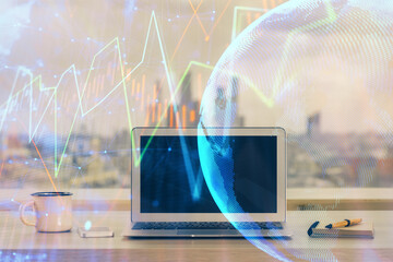 Financial chart drawing and table with computer on background. Double exposure. Concept of international markets.