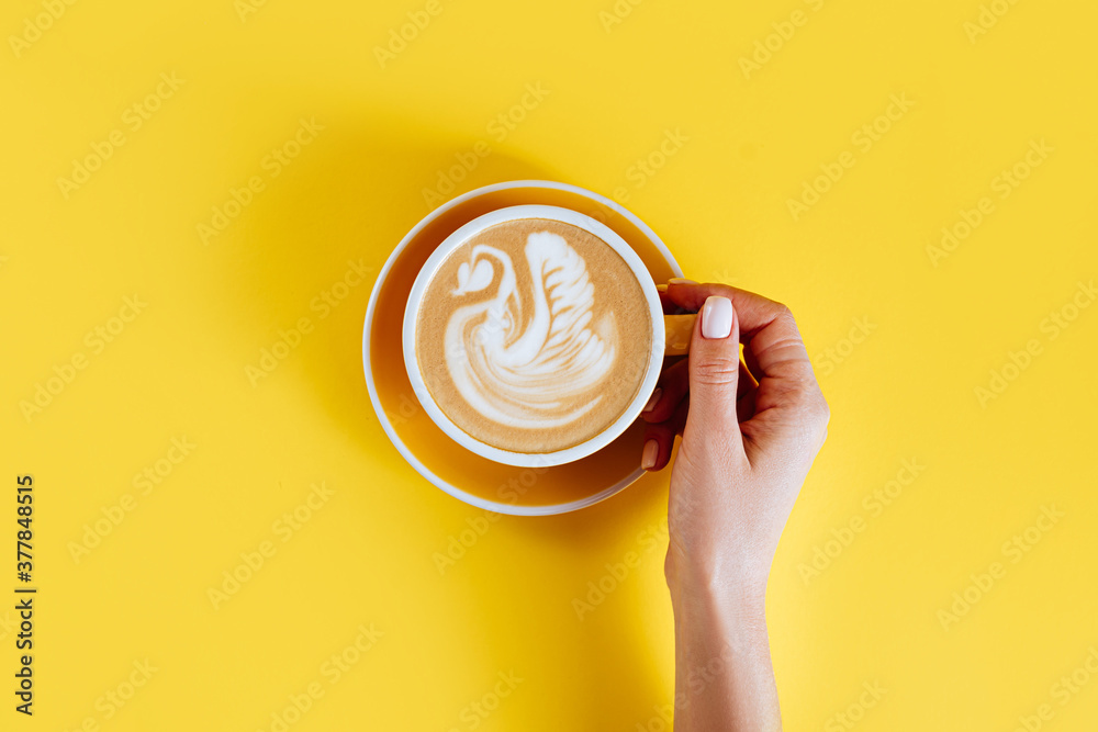 Wall mural Coffee latte art on yellow color background