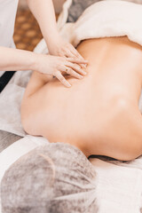 Obraz na płótnie Canvas Woman masseur doing back massage with hands - back pain treatment