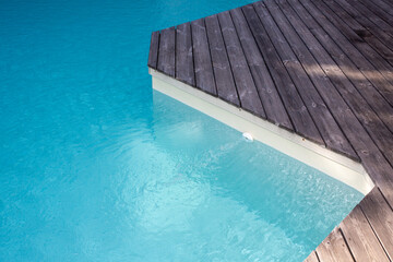 Fototapeta na wymiar blue pool beach with wooden terrace