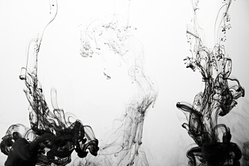 Closeup of a black ink in water in motion isolated on white. Ink swirling underwater. Colored abstract smoke explosion effect. Abstract background with copy space..