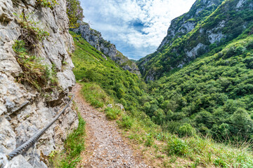 Fototapeta na wymiar Dangerous track along the ravine with ropes
