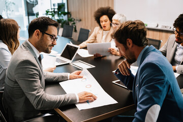Group of business people working together, brainstorming in office