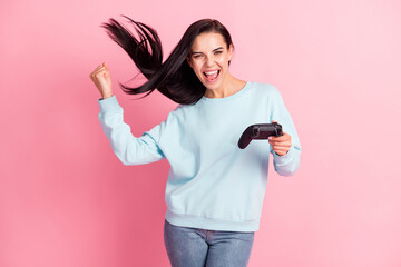 Photo of addicted gamer lady hold joystick playstation winner player wear pullover jeans isolated pink color background © deagreez
