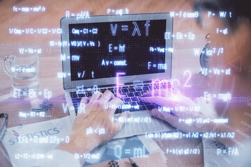 Science formula hologram with man working on computer on background. Education concept. Double...
