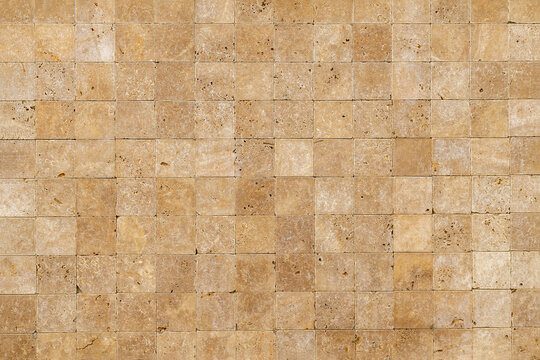 Wall background with Yellow natural sandstone tiles stiched together with clay