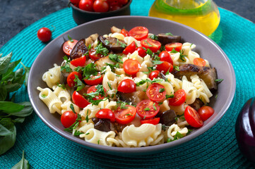 Pasta creste with grilled eggplant, cherry tomatoes and herbs. Delicious warm salad.