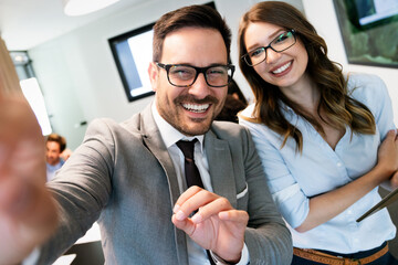 Happy business people having fun and chatting at workplace office