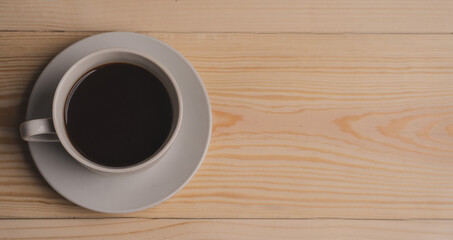 warm cup of coffee on brown background