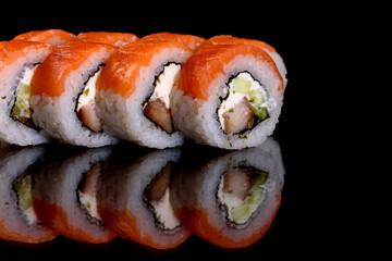 Fresh delicious beautiful sushi rolls on a dark background