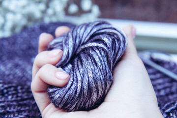 Needlework. Texture beautiful knitted bright violet fabric with metallic fibers and knitting...