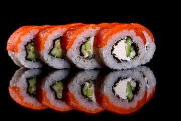 Fresh delicious beautiful sushi rolls on a dark background