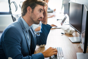 Fototapeta premium Overworked tired employee at workplace in office being unhappy
